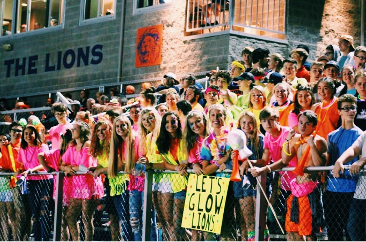 The Crazies support their lions by dressing in neon attire at the first home game on the season.