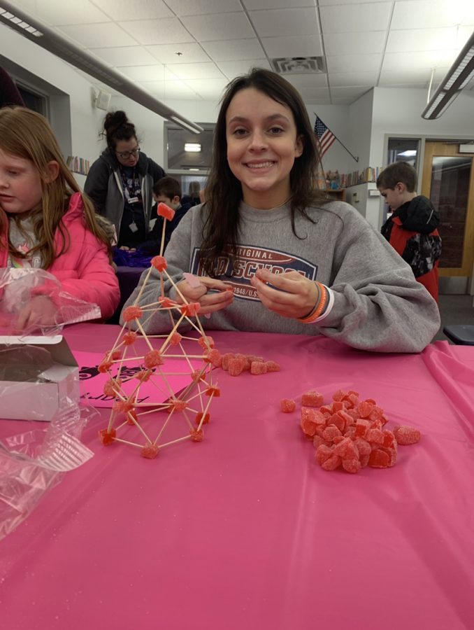 New member, Annie Mitchell, smiles for the camera during the Tri-c Elementary STEAM (Science, Technology, Engineering, Arts, and Mathematics) while working at the gummy rocket building station.