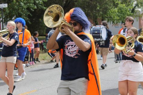 Haresh Kittu (12) plays the french horn while walking in the homecoming parade.