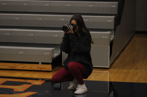 Senior, Natalie Vanderzille taking a picture at the boys basketball game on January 26th. 