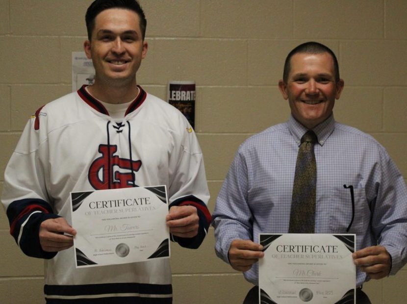 Mr.Towers and Mr.Clark holding their superlatives together as they get their photo taken.