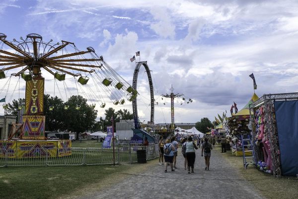 Visitors enjoying the DuQuoin State Fair with all of the different events, rides, and food. 
