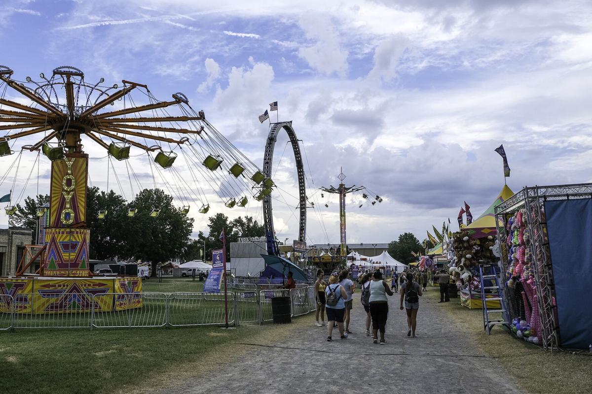 Visitors enjoying the DuQuoin State Fair with all of the different events, rides, and food. 