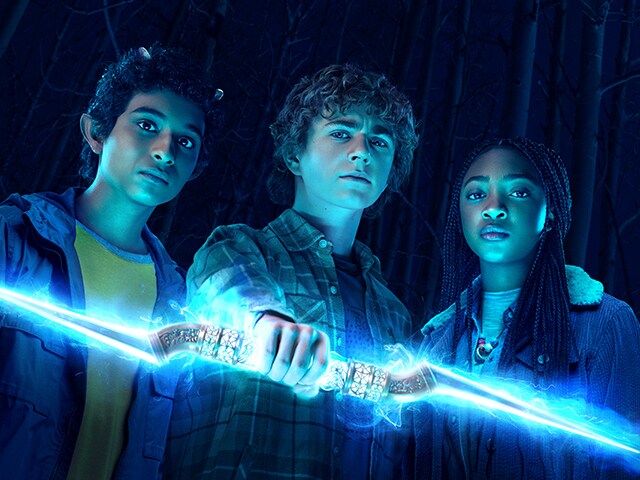 Characters Grover, Percy Jackson, and Annabeth Chase holding the lightning bolt.