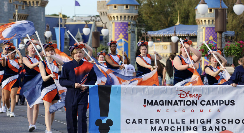 The+Carterville+Marching+band+and+Color+guard+team+marching+down+main+street+in+front+of+the+Magic+Kingdom+Castle.