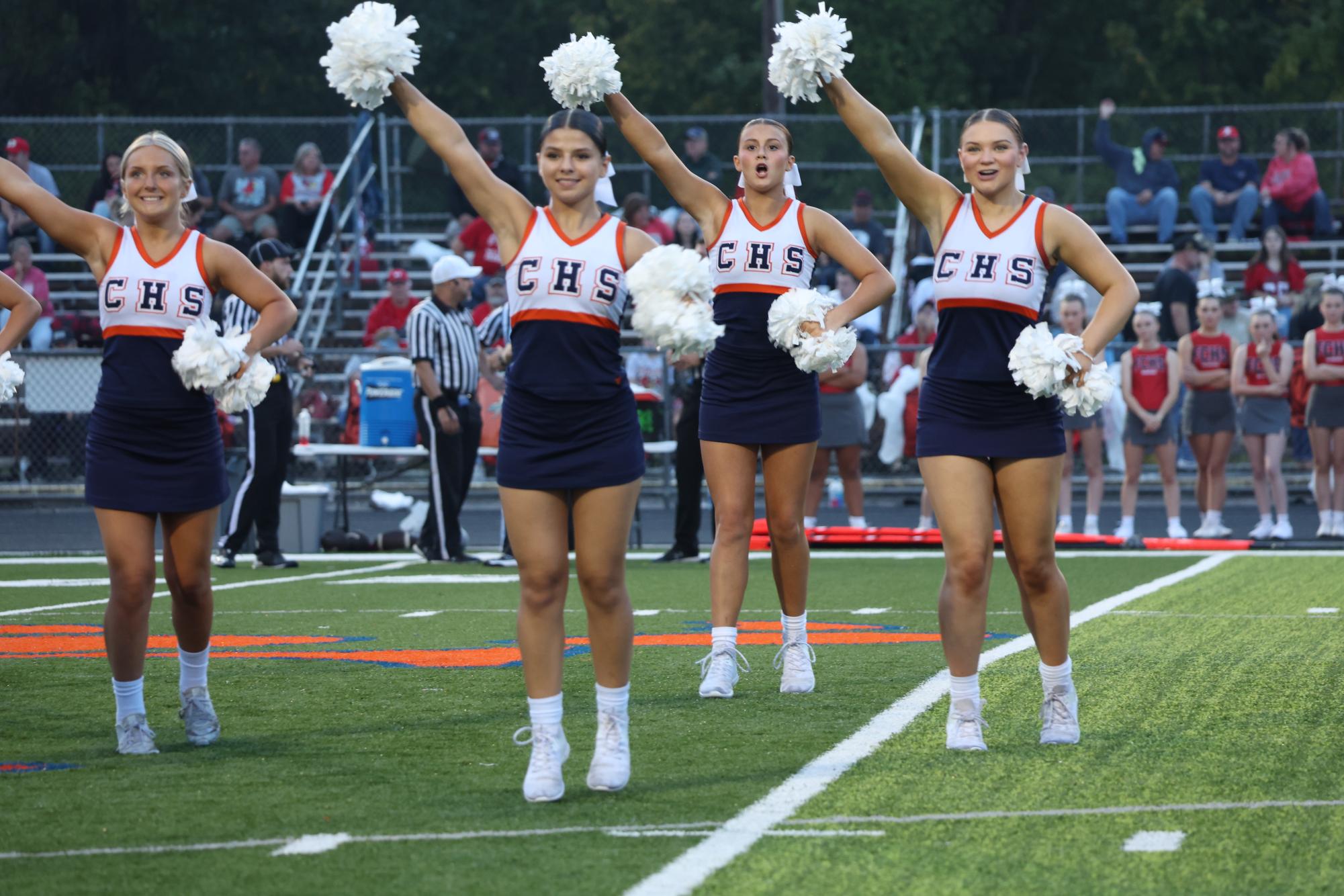 Hayden Harmon (10), Annalise Blumenstien (9), Lynzee Crespi (12), and Emma Burzynski (11) all perform school song at the Homecoming game.