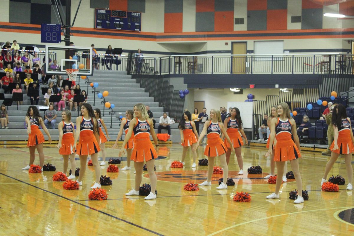 The dance team hits their last move at the pep rally after their performance.