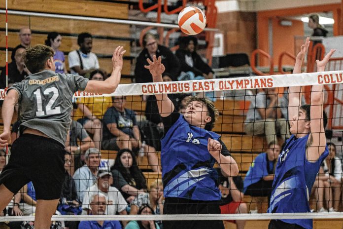 Columbus East’s Alex Duncan, from left, tries to hit the ball past Columbus North’s Isaac Riddle and Isaac Proffitt during a boys volleyball game at Columbus East High School in Columbus, Ind., Tuesday, May 9, 2023.