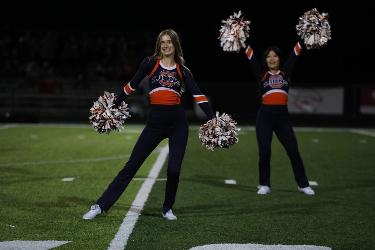 Olivia Doering (12) smiles while dancing during halftime. 