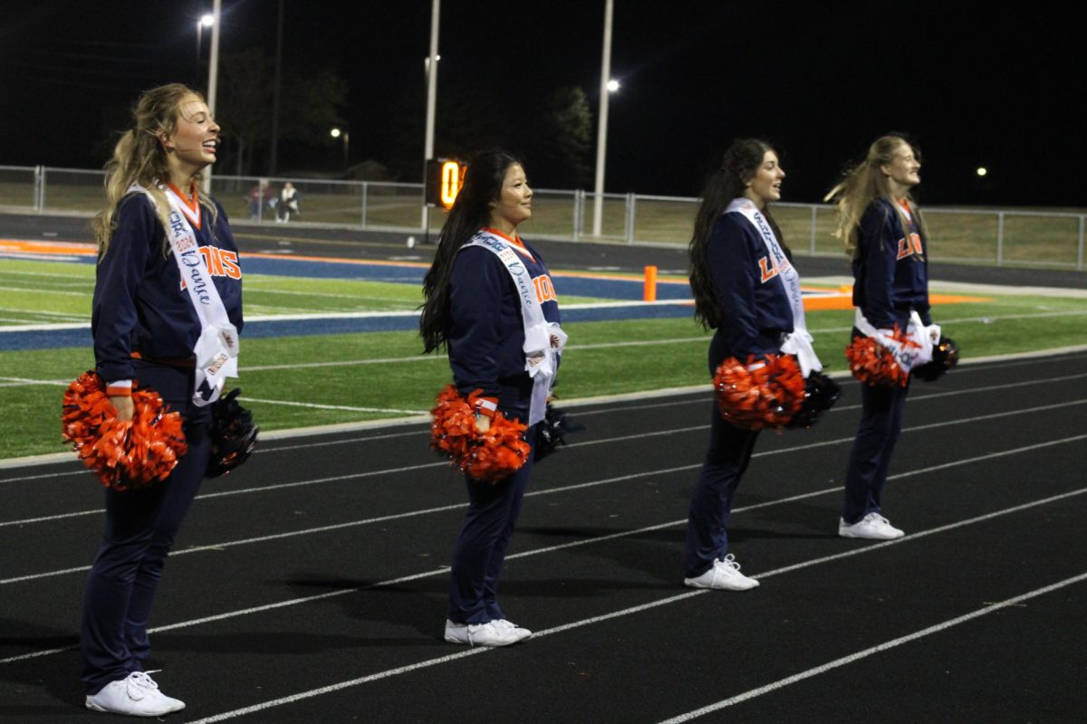 Dance seniors stand in a line as they prepare to perform school song one last time.