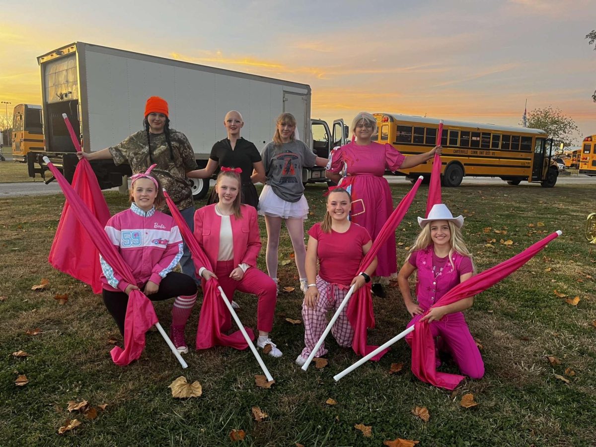 With the season coming to a close, the 2024-2025 Color Guard team celebrates their successful season at the Pinckneyville Halloween parade. 