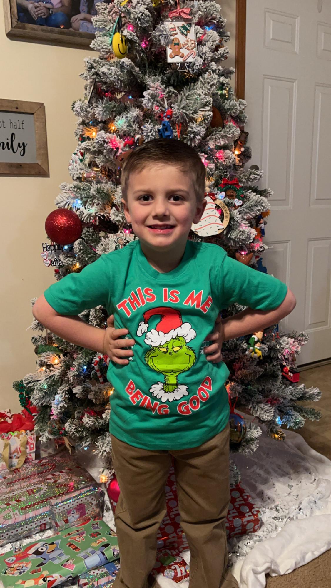 Jaxon Halliday (4) posed Infront of the tree wearing one of his favorite Christmas movies on his shirt.