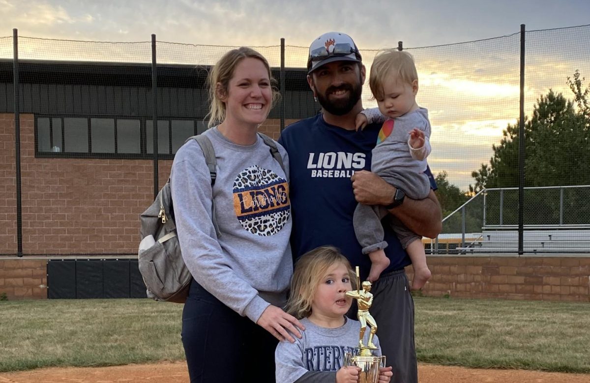 After a long evening at baseball, Mr. Cure and his family pose for a photo after the Junior High Regional Championship.