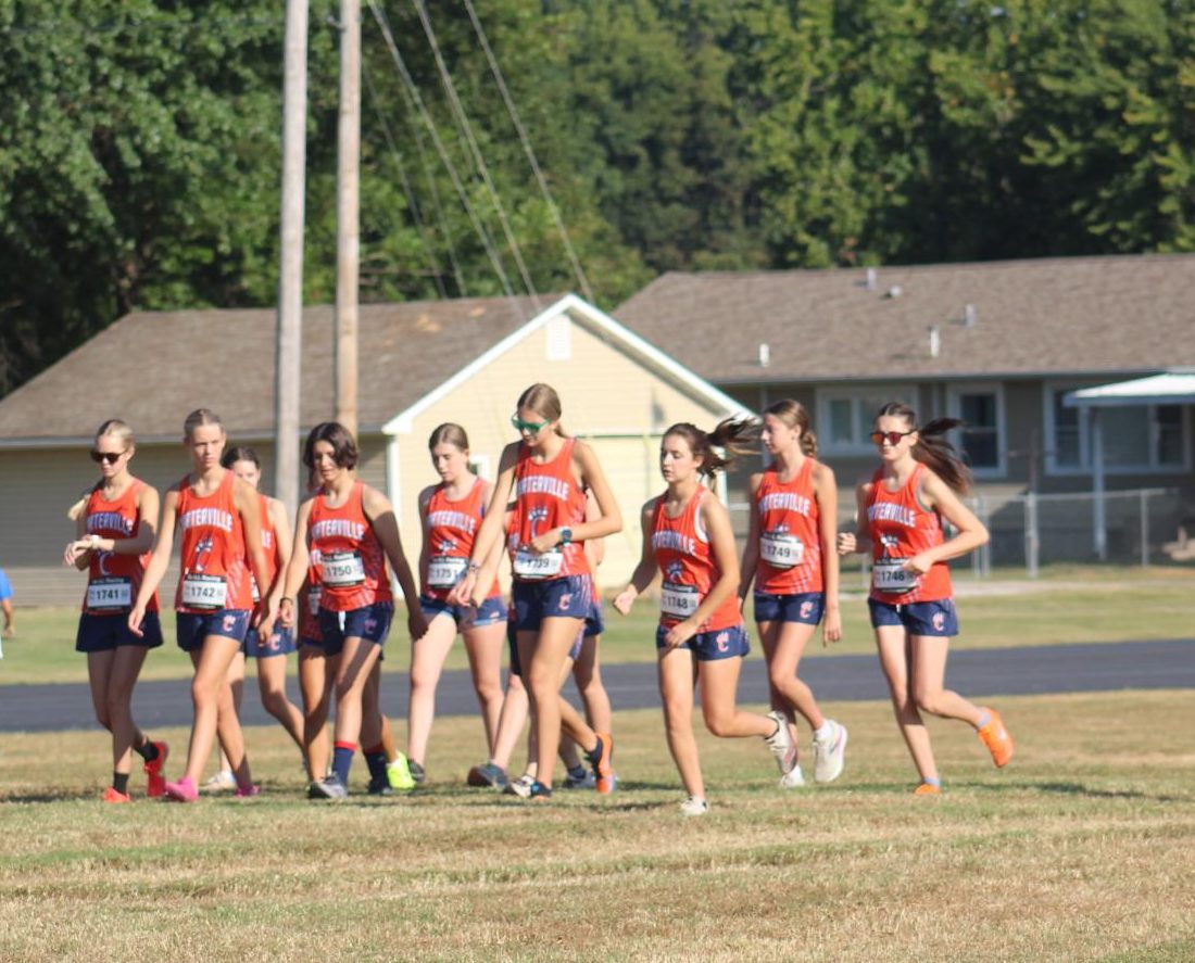 The girls Cross Country team warming up before they start the race.