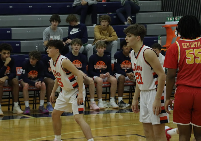 Senior Colton Hawkins (21) and Junior Maddox Gulley (25) playing defense against the Murphysboro Basketball Team.