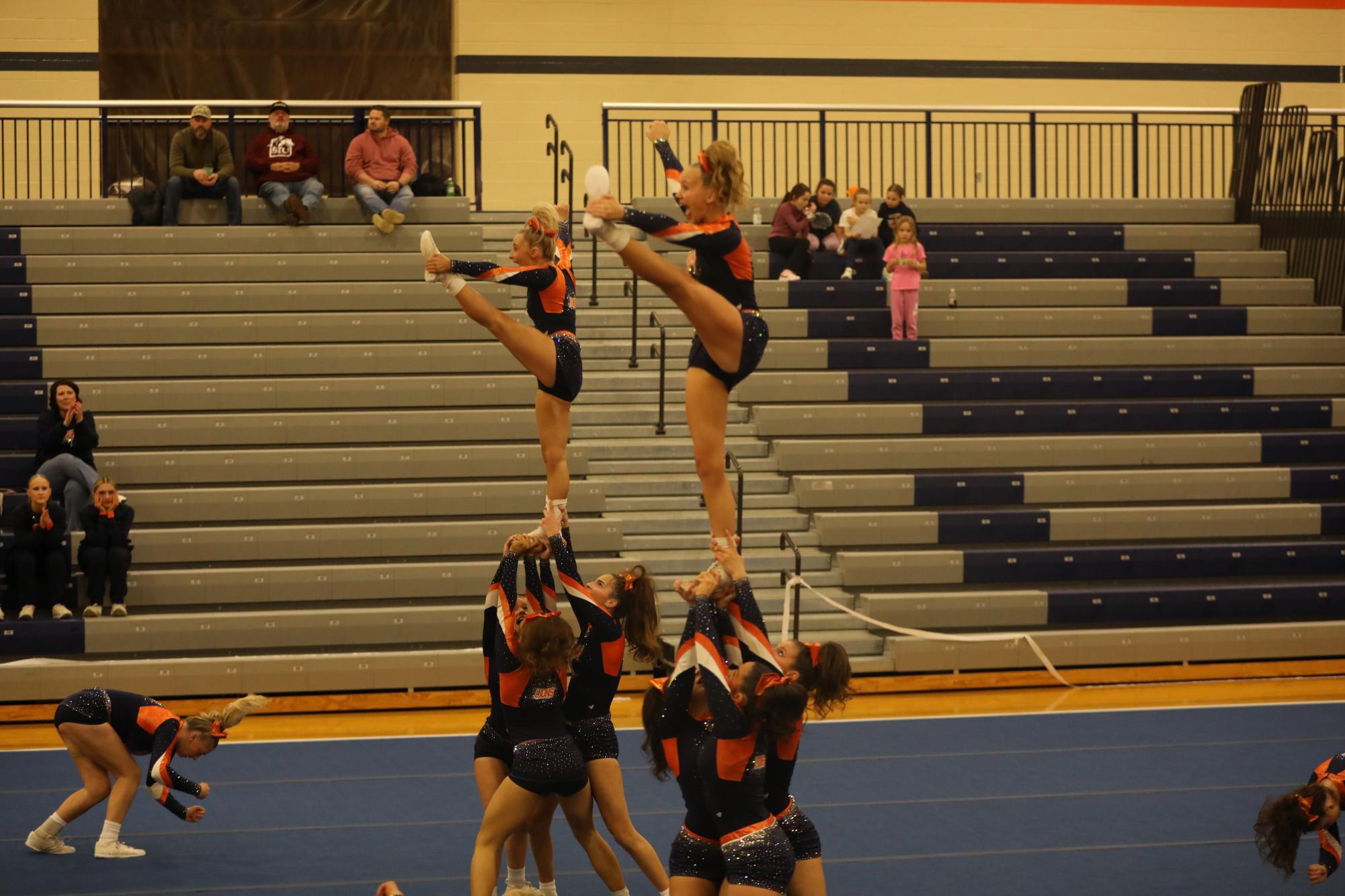 Senior Addy Horn and freshmen Avery Shasteen are flying body positions at the Carterville competition.