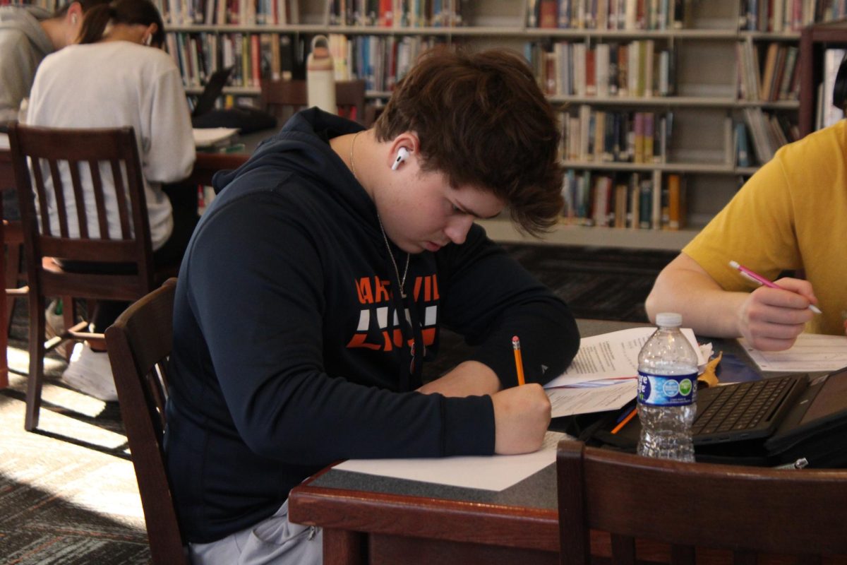 Junior Bryce Phillips is seen studying in the library. Students often take time in their study hall to prepare for exams, including the ACT. 