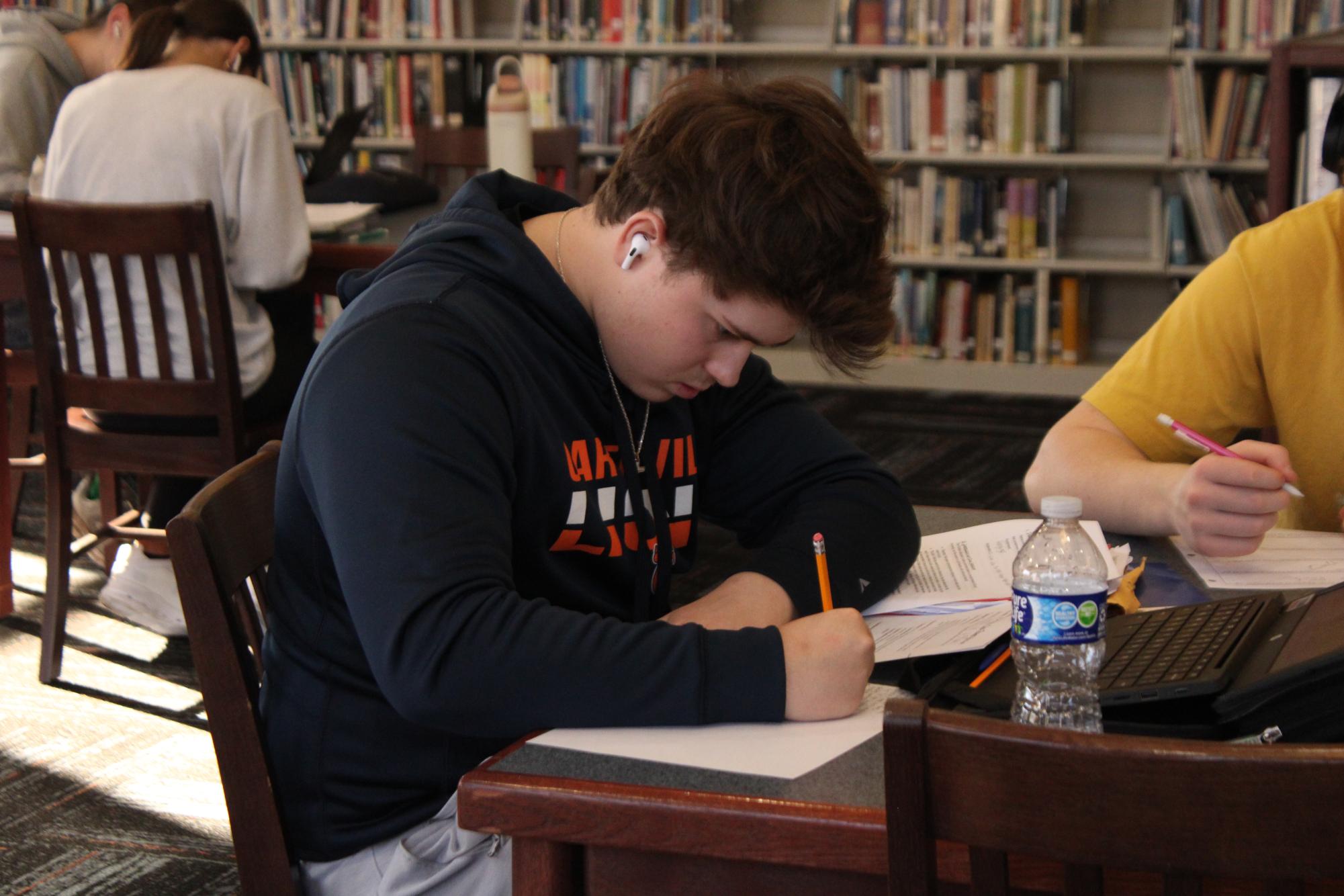 Junior Bryce Phillips is seen studying in the library. Students often take time in their study hall to prepare for exams, including the ACT. 