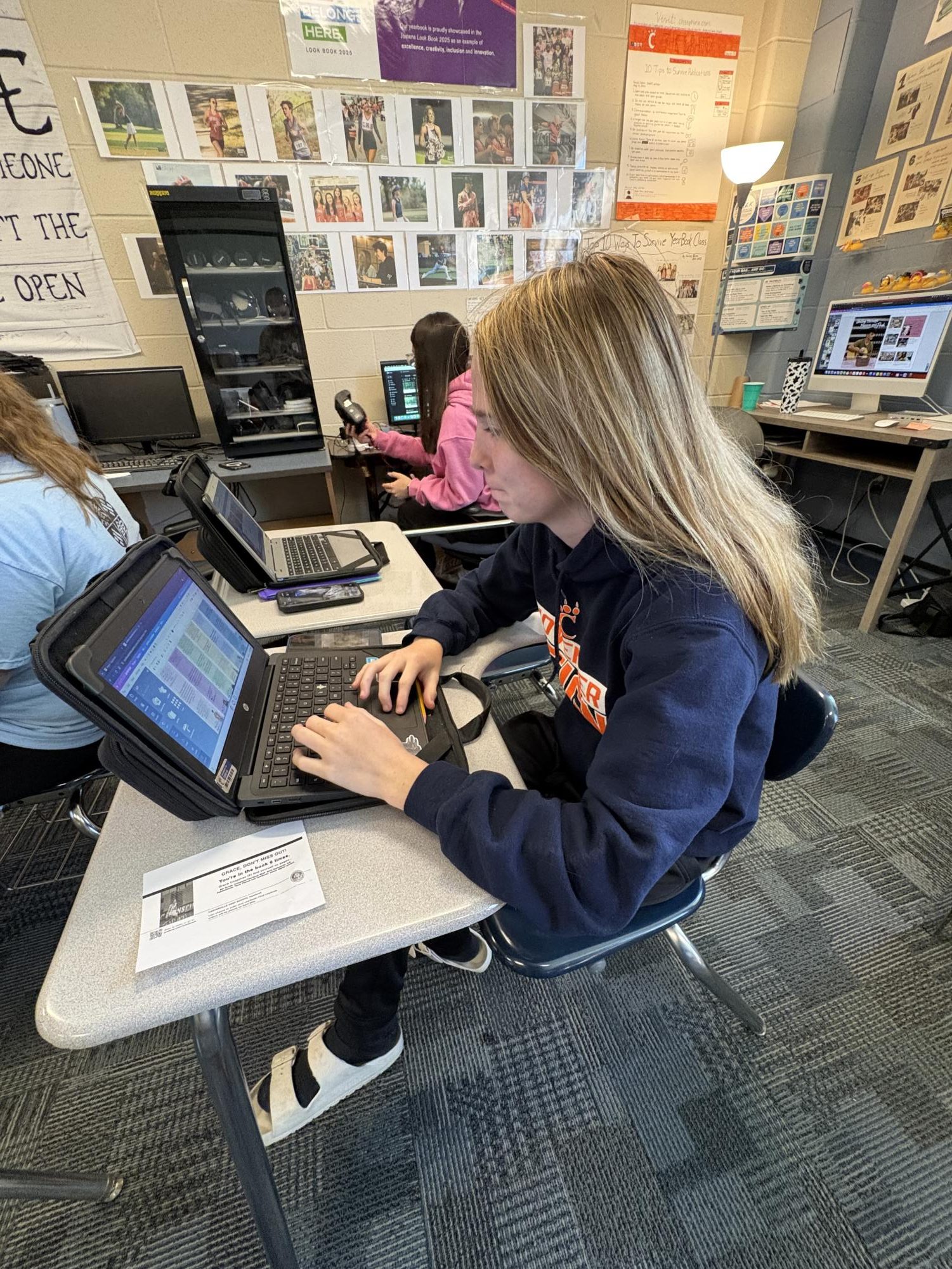 Freshman Grace Chapman is working on her yearbook homework. 